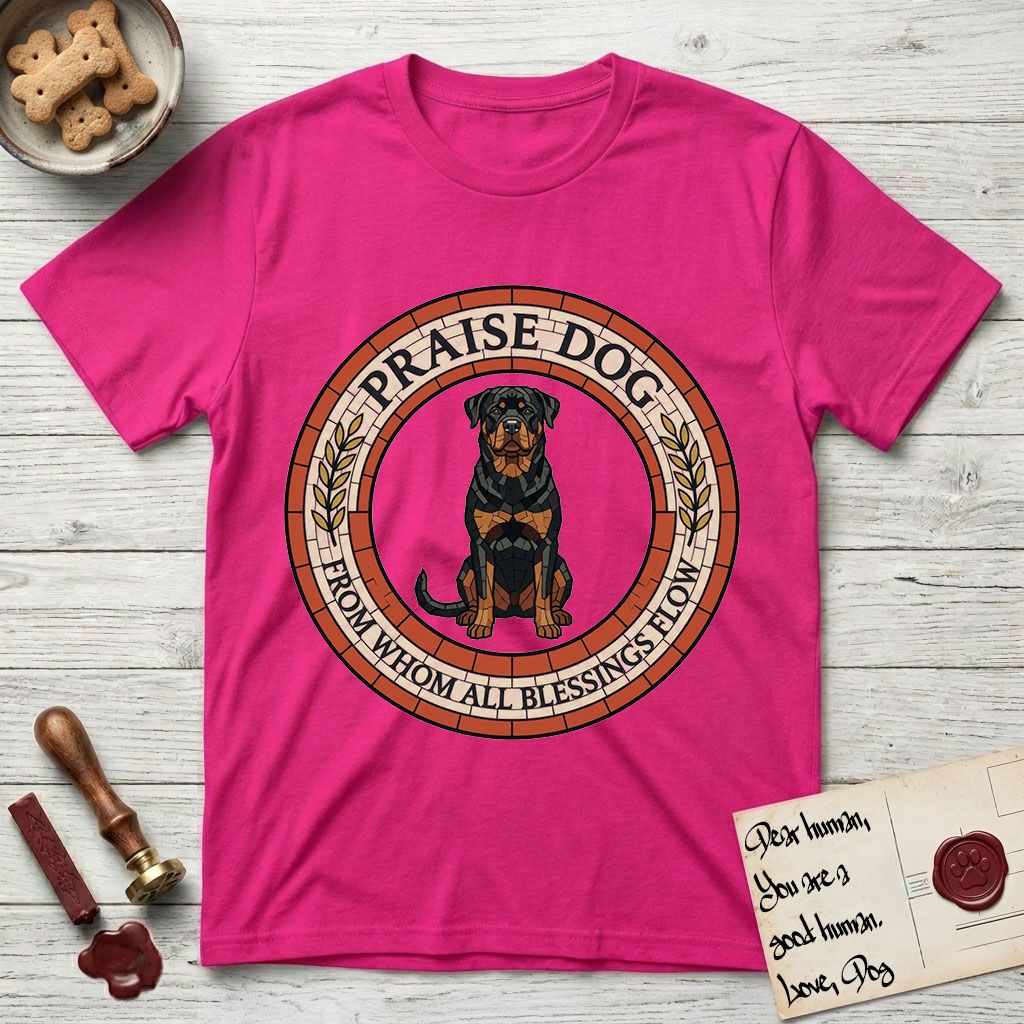 Praise Dog From Whom All Blessings Flow Rottweiler T-Shirt flat lay in Heliconia, featuring a Roman mosaic ring medallion of a seated Rottweiler with natural ears and a full undocked tail, built from terracotta and mahogany tiles and flanked by laurel branches, with "Praise Dog From Whom All Blessings Flow" lettering.