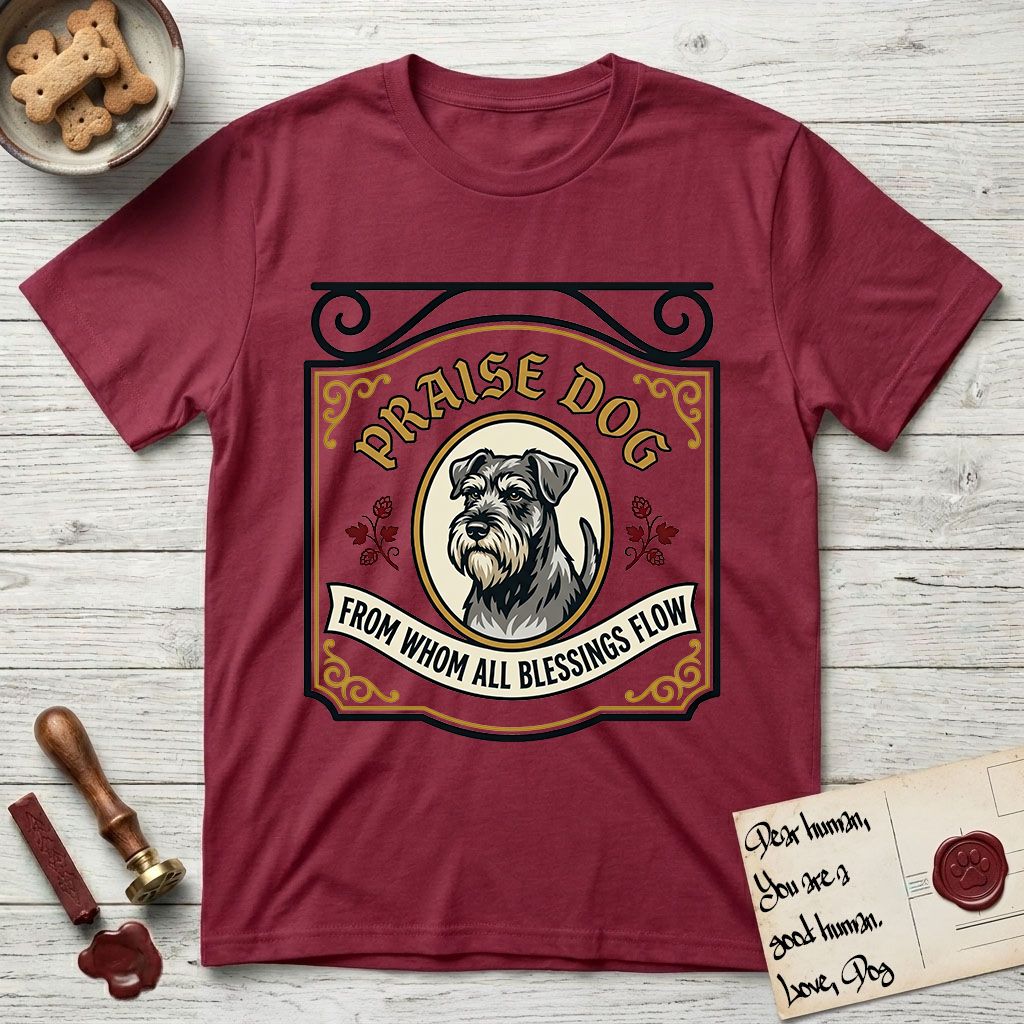 Praise Dog From Whom All Blessings Flow Schnauzer T-Shirt flat lay in Cardinal Red, featuring a vintage tavern sign with a bearded Schnauzer portrait in a gilded oval, hops sprigs, and a ribbon banner, with the words Praise Dog From Whom All Blessings Flow.