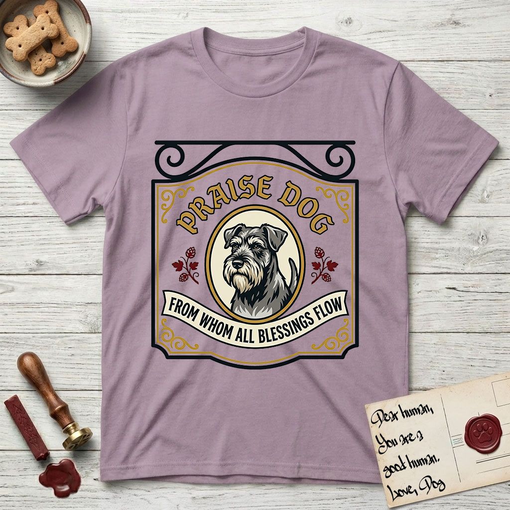 Praise Dog From Whom All Blessings Flow Schnauzer T-Shirt flat lay in Paragon, featuring a vintage tavern sign with a bearded Schnauzer portrait in a gilded oval, hops sprigs, and a ribbon banner, with the words Praise Dog From Whom All Blessings Flow.