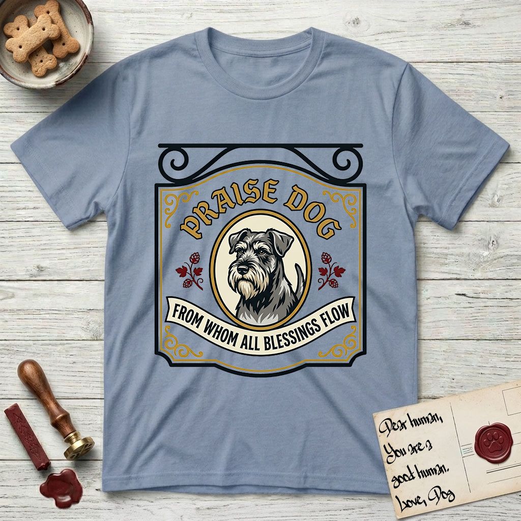 Praise Dog From Whom All Blessings Flow Schnauzer T-Shirt flat lay in Stone Blue, featuring a vintage tavern sign with a bearded Schnauzer portrait in a gilded oval, hops sprigs, and a ribbon banner, with the words Praise Dog From Whom All Blessings Flow.