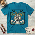 Praise Dog From Whom All Blessings Flow Schnauzer T-Shirt flat lay in Tropical Blue, featuring a vintage tavern sign with a bearded Schnauzer portrait in a gilded oval, hops sprigs, and a ribbon banner, with the words Praise Dog From Whom All Blessings Flow.