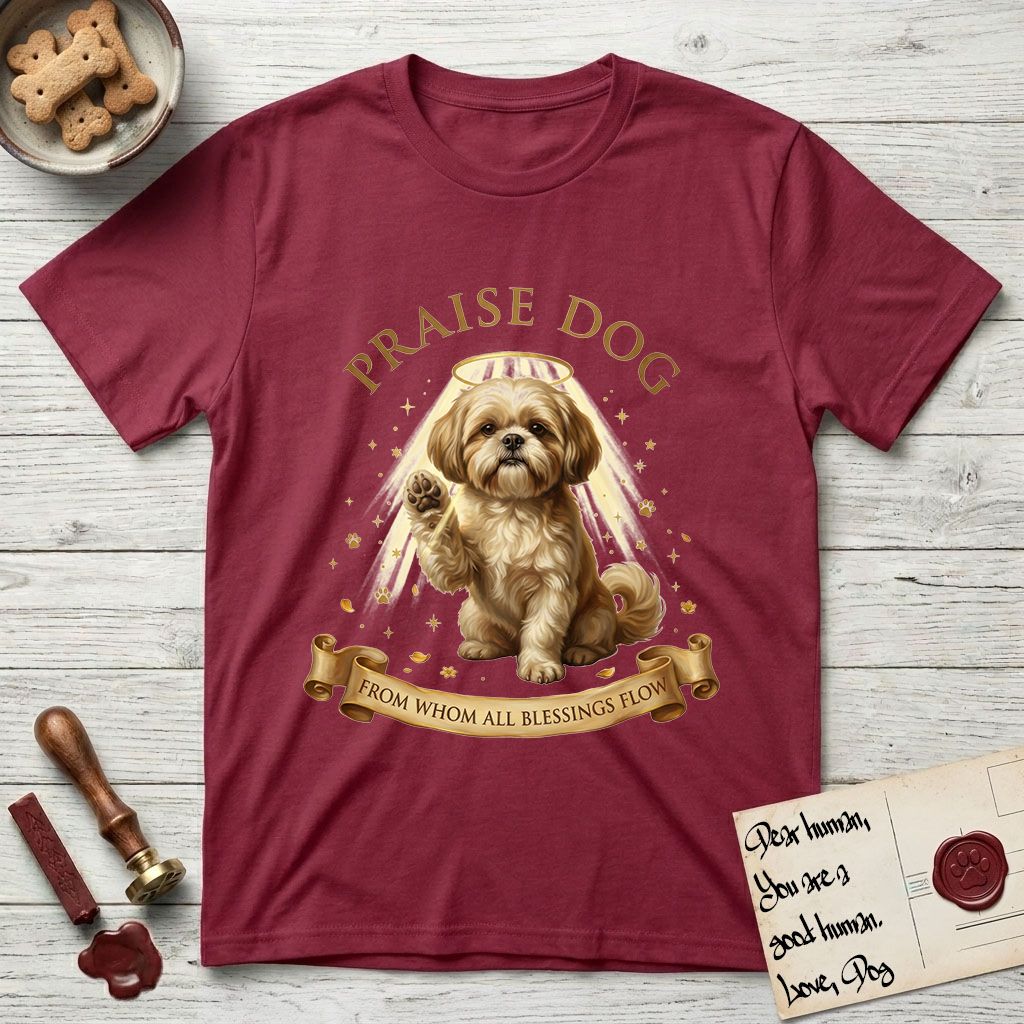 Praise Dog From Whom All Blessings Flow Shih Tzu T-Shirt flat lay in Cardinal Red, featuring an old-master devotional oil painting of a Shih Tzu seated with one paw raised in blessing, a floating gold halo and streaming light, a shower of small gold blessings, and gilt "Praise Dog From Whom All Blessings Flow" lettering on a ribbon scroll.