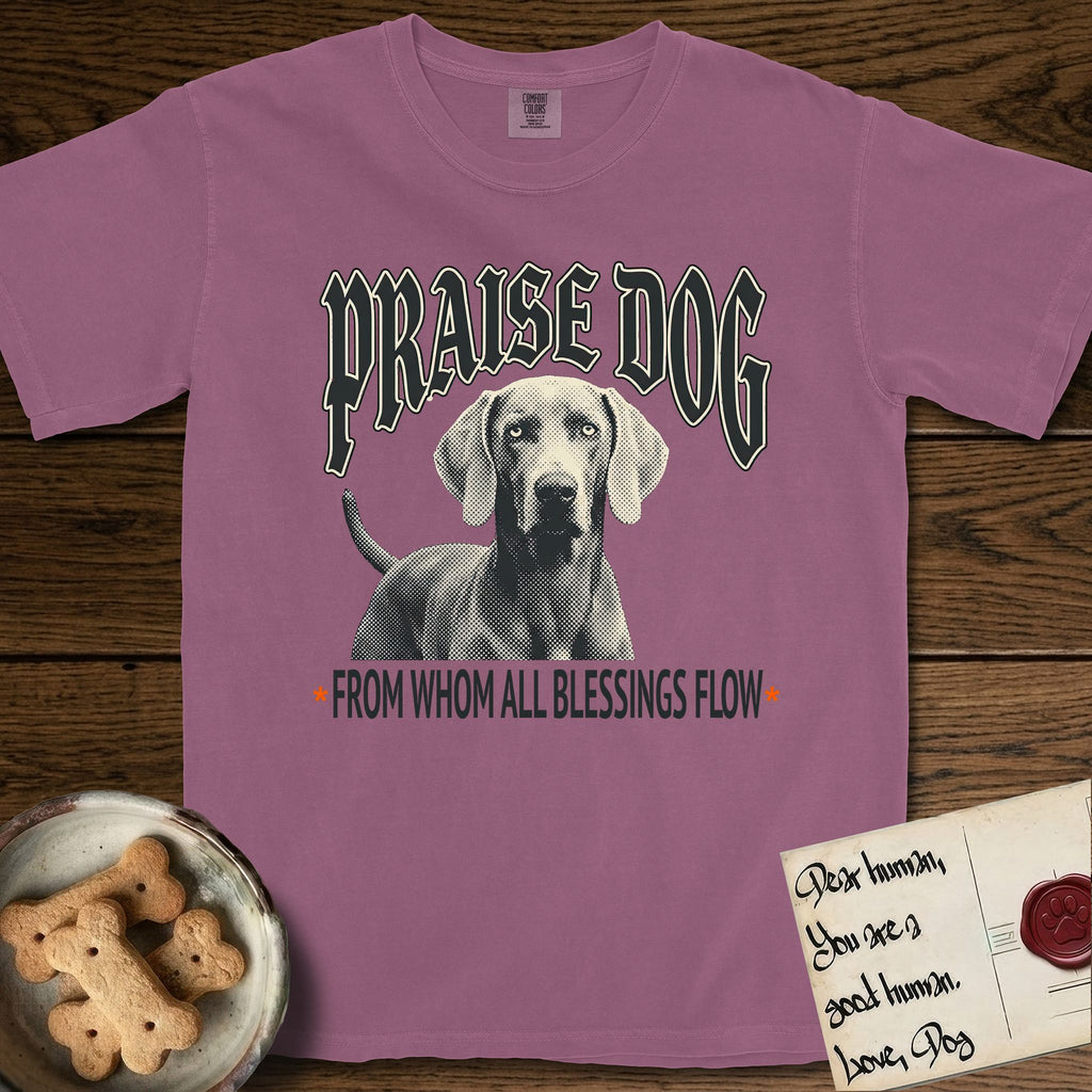 Praise Dog From Whom All Blessings Flow Weimaraner T-Shirt flat lay in Berry, featuring a gothic halftone poster with a Weimaraner staring straight ahead beneath heavy blackletter lettering and the words Praise Dog From Whom All Blessings Flow.