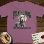 Praise Dog From Whom All Blessings Flow Weimaraner T-Shirt flat lay in Berry, featuring a gothic halftone poster with a Weimaraner staring straight ahead beneath heavy blackletter lettering and the words Praise Dog From Whom All Blessings Flow.