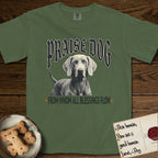 Praise Dog From Whom All Blessings Flow Weimaraner T-Shirt flat lay in Moss, featuring a gothic halftone poster with a Weimaraner staring straight ahead beneath heavy blackletter lettering and the words Praise Dog From Whom All Blessings Flow.