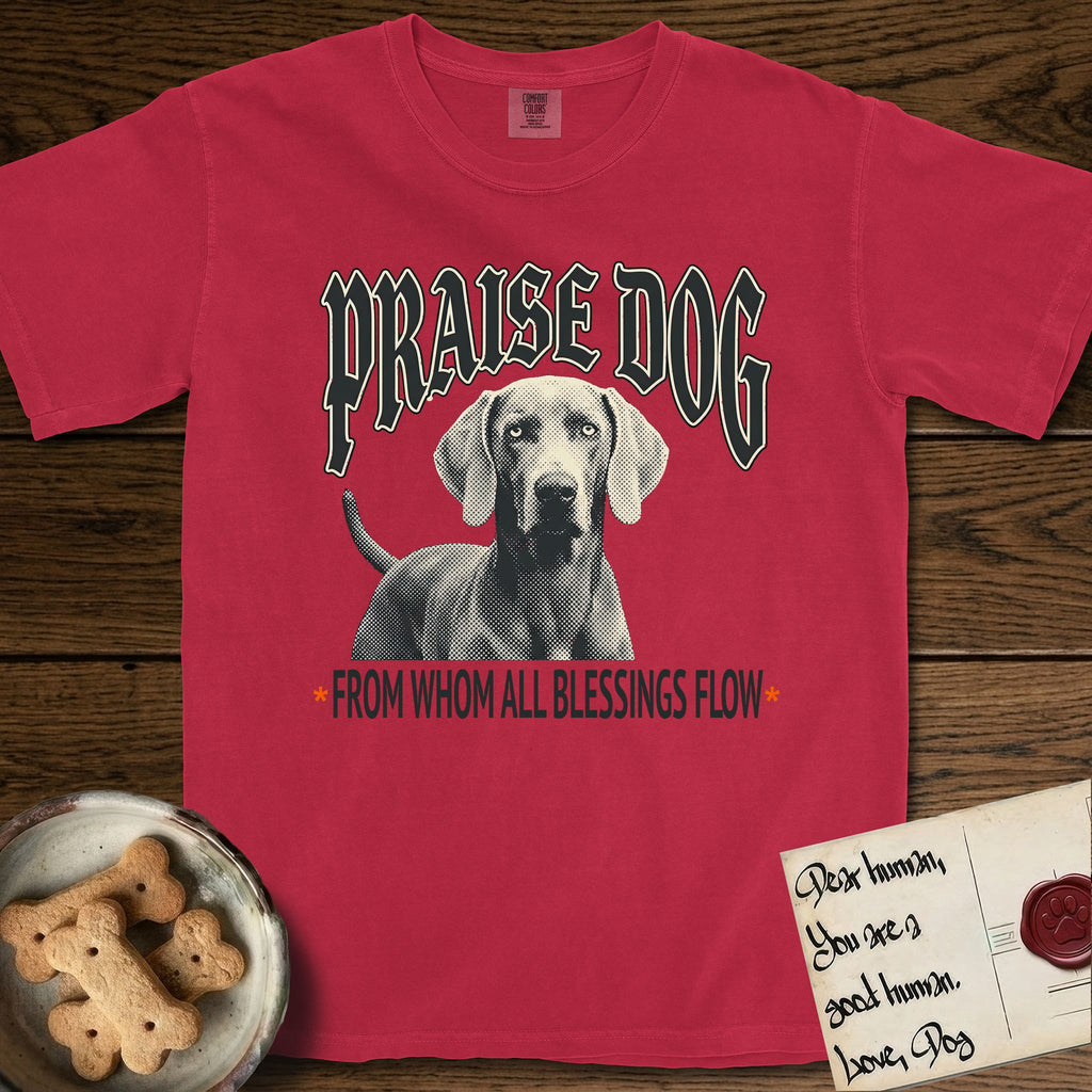 Praise Dog From Whom All Blessings Flow Weimaraner T-Shirt flat lay in Red, featuring a gothic halftone poster with a Weimaraner staring straight ahead beneath heavy blackletter lettering and the words Praise Dog From Whom All Blessings Flow.
