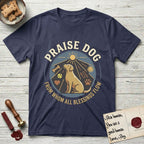 Praise Dog From Whom All Blessings Flow Yellow Lab T-Shirt flat lay in Navy, featuring a warm vintage circular emblem with an upward-gazing Yellow Lab, a sunburst, and a devotional border of small hearts and stars.
