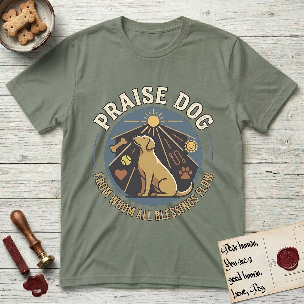 Praise Dog From Whom All Blessings Flow Yellow Lab T-Shirt flat lay in Sage, featuring a warm vintage circular emblem with an upward-gazing Yellow Lab, a sunburst, and a devotional border of small hearts and stars.