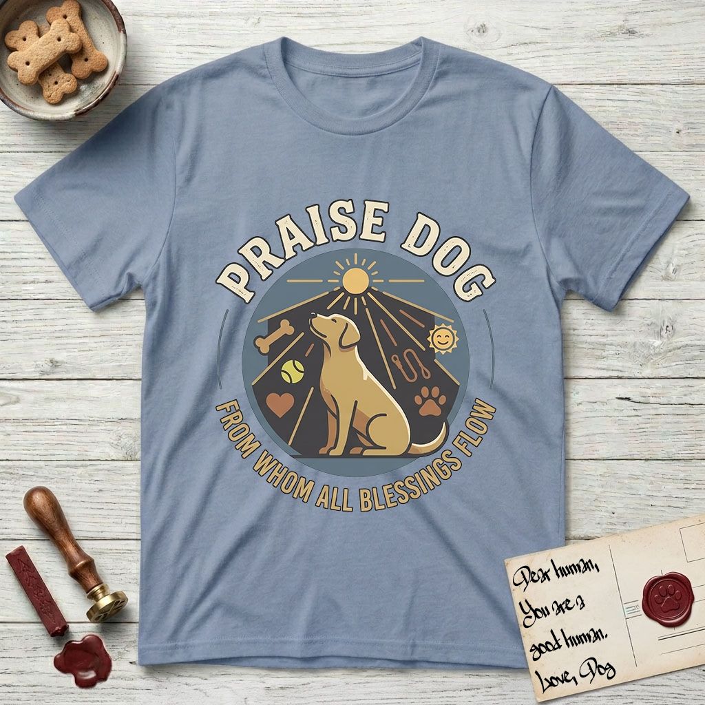 Praise Dog From Whom All Blessings Flow Yellow Lab T-Shirt flat lay in Stone Blue, featuring a warm vintage circular emblem with an upward-gazing Yellow Lab, a sunburst, and a devotional border of small hearts and stars.