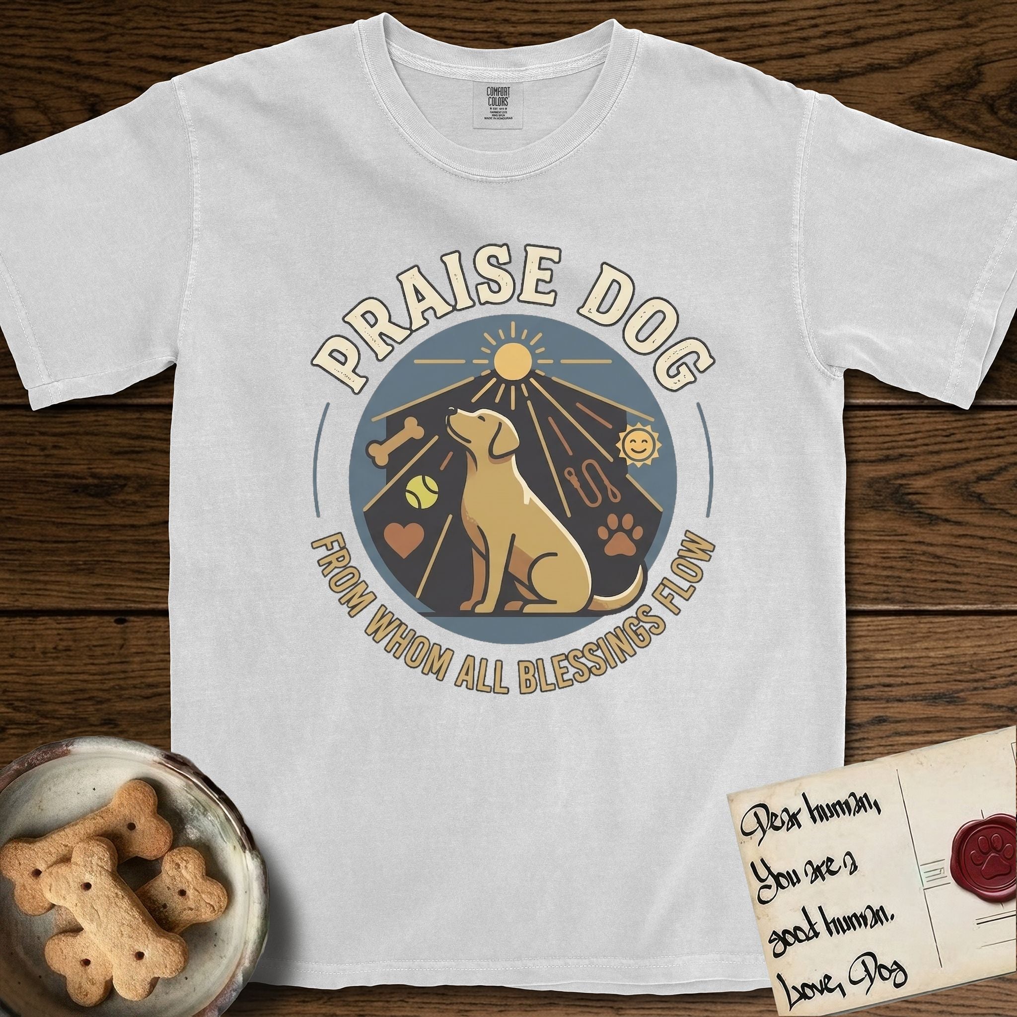 Praise Dog From Whom All Blessings Flow Yellow Lab T-Shirt flat lay in White, featuring a warm vintage circular emblem with an upward-gazing Yellow Lab, a sunburst, and a devotional border of small hearts and stars.