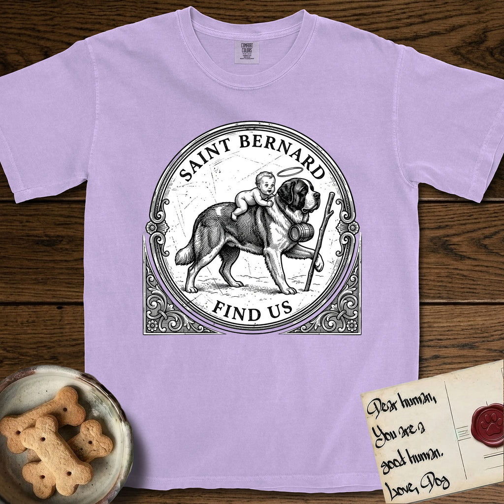 Patron Saint Medallion Saint Bernard T-Shirt flat lay in Orchid, featuring a vintage engraving coin medallion of a haloed Saint Bernard carrying a child across a mountain pass, with the petition FIND US.
