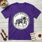 Patron Saint Medallion Saint Bernard T-Shirt flat lay in Purple, featuring a vintage engraving coin medallion of a haloed Saint Bernard carrying a child across a mountain pass, with the petition FIND US.