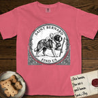Patron Saint Medallion Saint Bernard T-Shirt flat lay in Watermelon, featuring a vintage engraving coin medallion of a haloed Saint Bernard carrying a child across a mountain pass, with the petition FIND US.