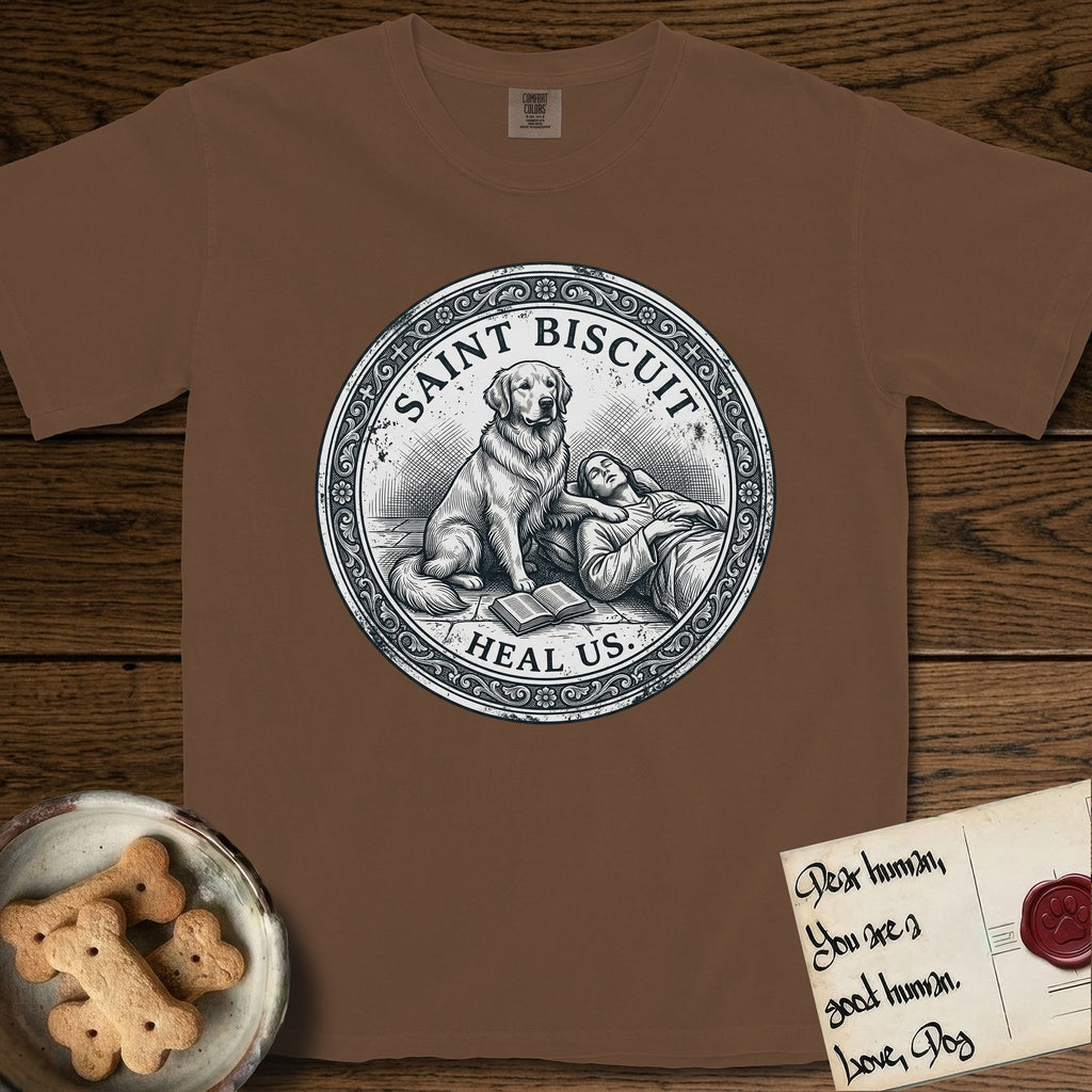 Patron Saint Medallion Saint Biscuit T-Shirt flat lay in Espresso, featuring a vintage engraving coin medallion of a haloed Golden Retriever with a devotee resting against her and an open book, with the petition HEAL US.