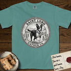 Patron Saint Medallion Saint Lobo T-Shirt flat lay in Blue Spruce, featuring a vintage engraving coin medallion of haloed Saint Lobo running across open ground, with the petition GATHER US.