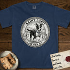 Patron Saint Medallion Saint Lobo T-Shirt flat lay in True Navy, featuring a vintage engraving coin medallion of haloed Saint Lobo running across open ground, with the petition GATHER US.