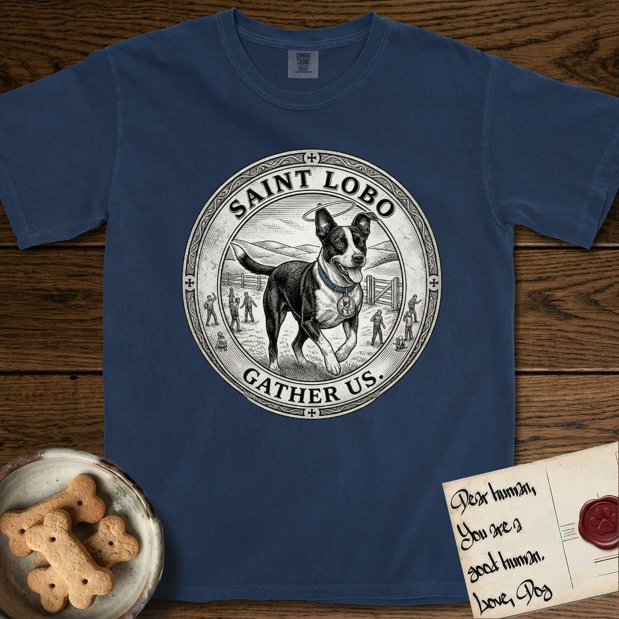 Patron Saint Medallion Saint Lobo T-Shirt flat lay in True Navy, featuring a vintage engraving coin medallion of haloed Saint Lobo running across open ground, with the petition GATHER US.