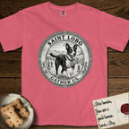 Patron Saint Medallion Saint Lobo T-Shirt flat lay in Watermelon, featuring a vintage engraving coin medallion of haloed Saint Lobo running across open ground, with the petition GATHER US.