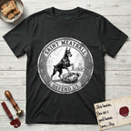 Patron Saint Medallion Saint Meatball T-Shirt flat lay in Black, featuring a vintage engraving coin medallion of a haloed Doberman rising on his hind legs, with the petition DEFEND US.