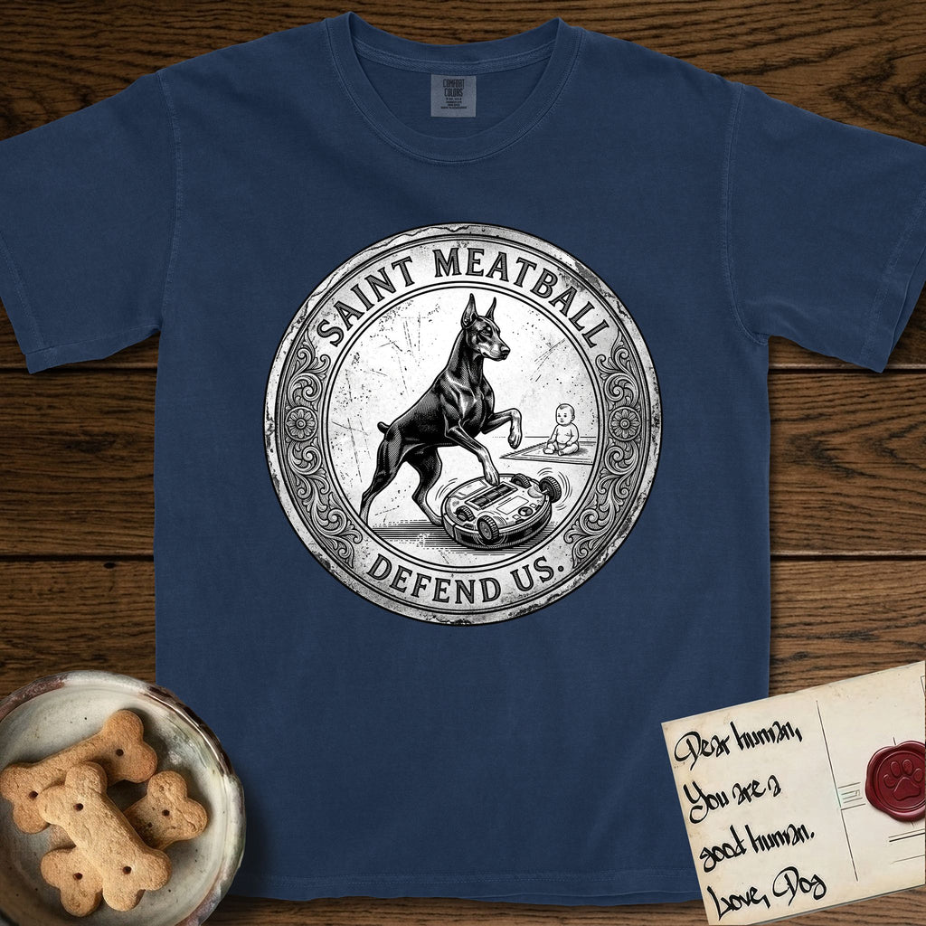 Patron Saint Medallion Saint Meatball T-Shirt flat lay in True Navy, featuring a vintage engraving coin medallion of a haloed Doberman rising on his hind legs, with the petition DEFEND US.