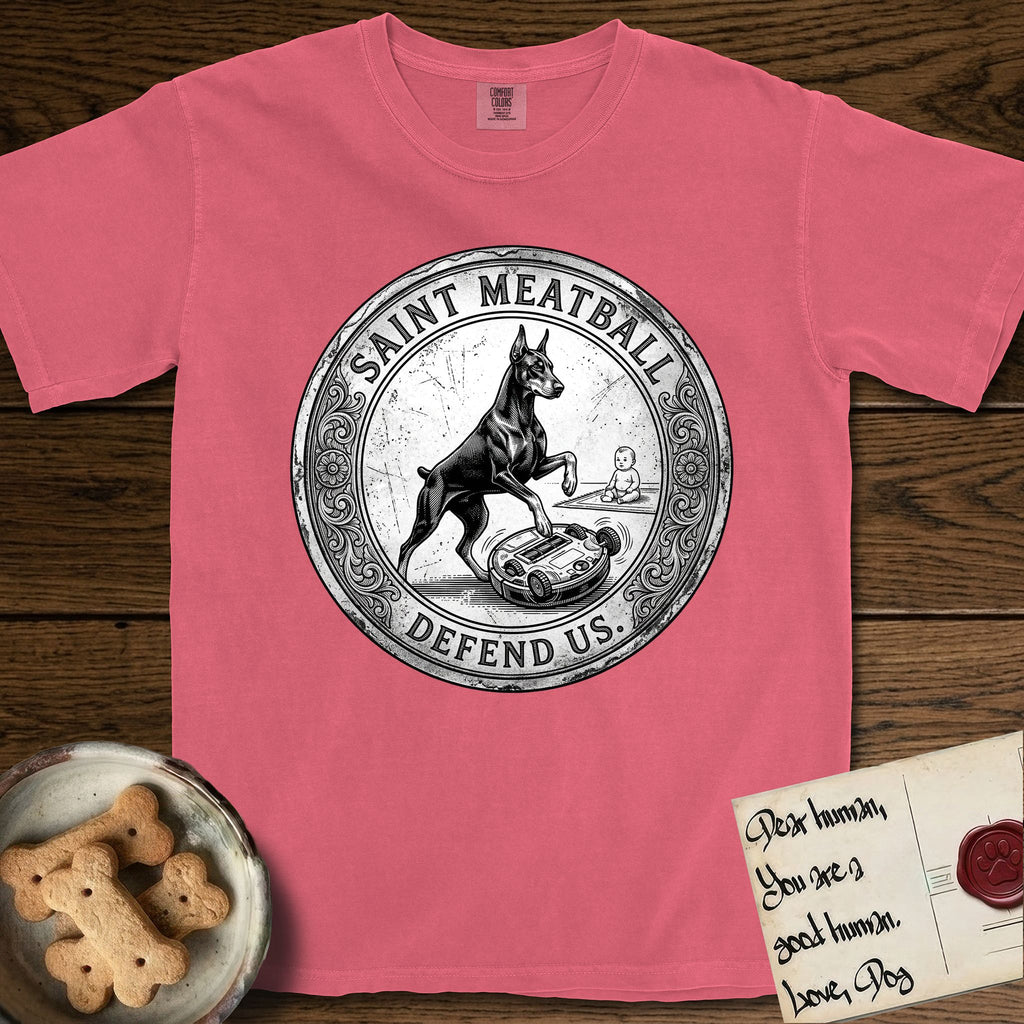 Patron Saint Medallion Saint Meatball T-Shirt flat lay in Watermelon, featuring a vintage engraving coin medallion of a haloed Doberman rising on his hind legs, with the petition DEFEND US.