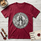Patron Saint Medallion Saint Noodles T-Shirt flat lay in Antique Cherry Red, featuring a vintage engraving coin medallion of a haloed Basset Hound with a staff and a child at her side, with the petition GUIDE US.