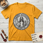 Patron Saint Medallion Saint Noodles T-Shirt flat lay in Gold, featuring a vintage engraving coin medallion of a haloed Basset Hound with a staff and a child at her side, with the petition GUIDE US.