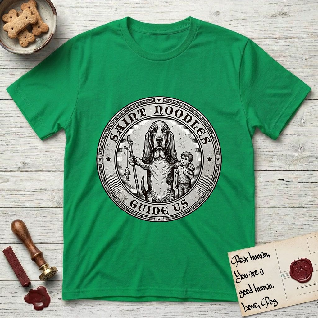 Patron Saint Medallion Saint Noodles T-Shirt flat lay in Irish Green, featuring a vintage engraving coin medallion of a haloed Basset Hound with a staff and a child at her side, with the petition GUIDE US.