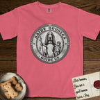 Patron Saint Medallion Saint Noodles T-Shirt flat lay in Watermelon, featuring a vintage engraving coin medallion of a haloed Basset Hound with a staff and a child at her side, with the petition GUIDE US.