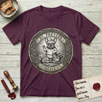 Patron Saint Medallion Saint Pretzel T-Shirt flat lay in Maroon, featuring an ornate vintage engraving coin medallion of a haloed French Bulldog raising one paw, a small bird on his head and woodland animals at his feet, with the petition FORGIVE US.