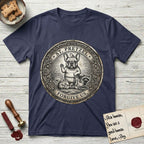Patron Saint Medallion Saint Pretzel T-Shirt flat lay in Navy, featuring an ornate vintage engraving coin medallion of a haloed French Bulldog raising one paw, a small bird on his head and woodland animals at his feet, with the petition FORGIVE US.