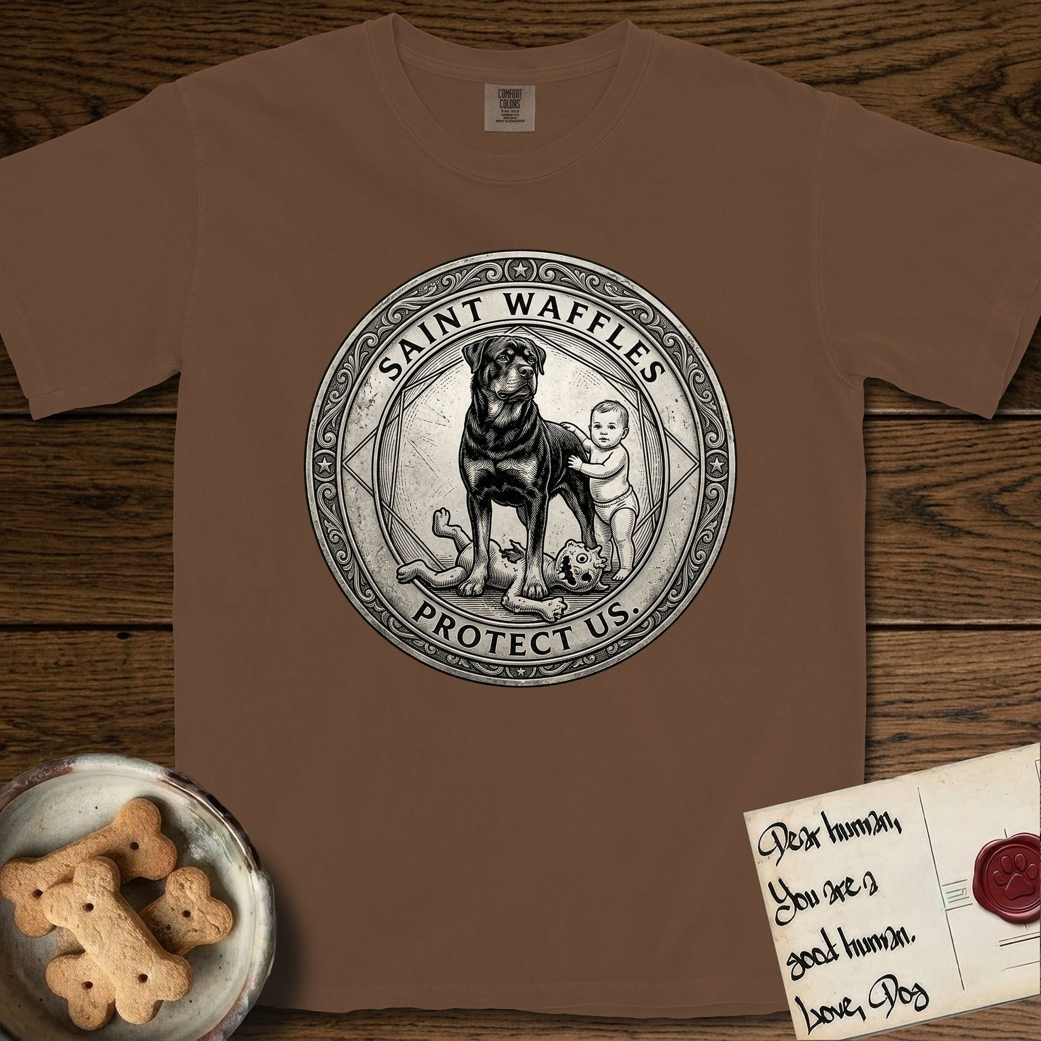 Patron Saint Medallion Saint Waffles T-Shirt flat lay in Espresso, featuring a vintage engraving coin medallion of a haloed Rottweiler standing guard over a small child, with the petition PROTECT US.