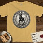 Patron Saint Medallion Saint Waffles T-Shirt flat lay in Mustard, featuring a vintage engraving coin medallion of a haloed Rottweiler standing guard over a small child, with the petition PROTECT US.
