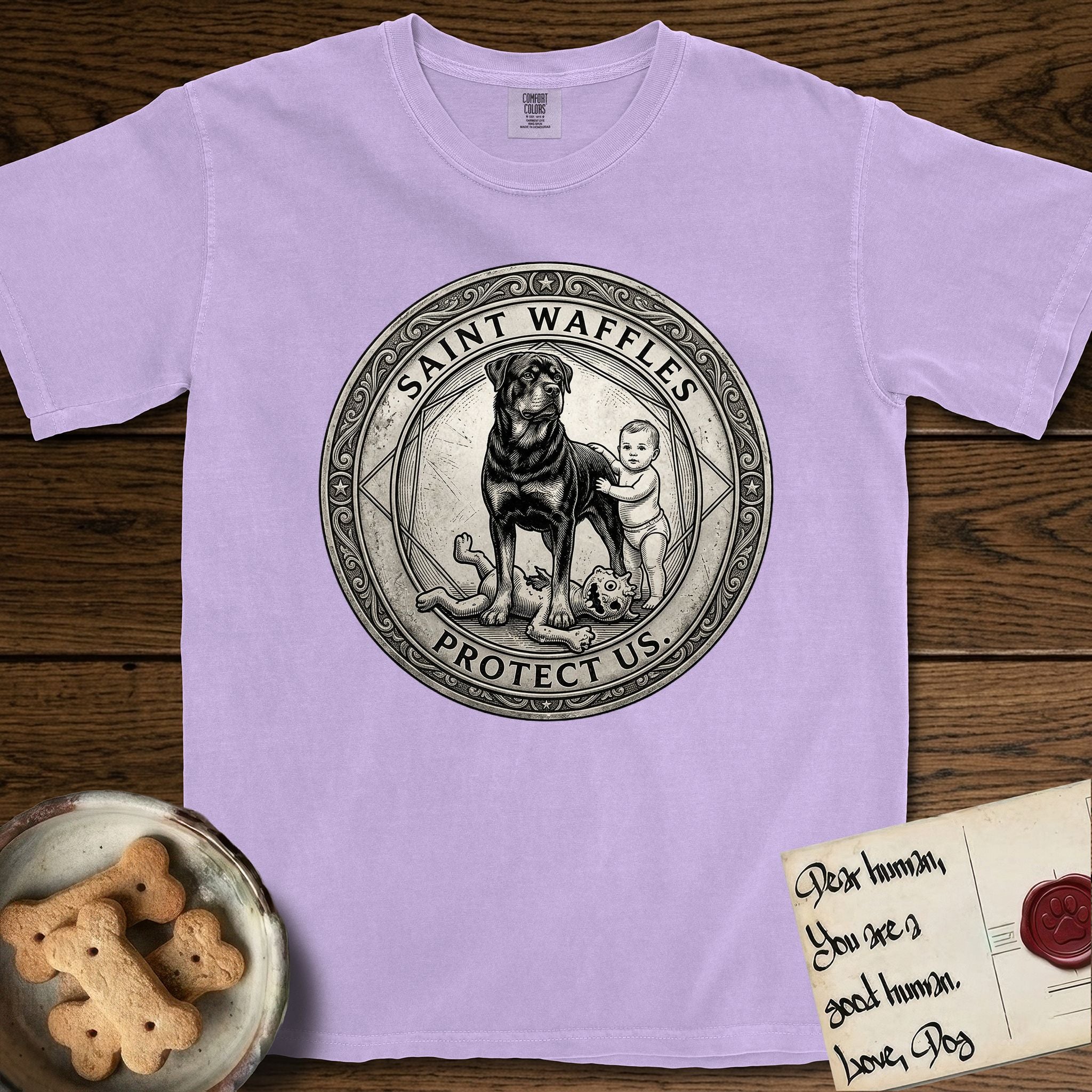 Patron Saint Medallion Saint Waffles T-Shirt flat lay in Orchid, featuring a vintage engraving coin medallion of a haloed Rottweiler standing guard over a small child, with the petition PROTECT US.
