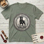 Patron Saint Medallion Saint Waffles T-Shirt flat lay in Sage, featuring a vintage engraving coin medallion of a haloed Rottweiler standing guard over a small child, with the petition PROTECT US.
