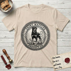 Patron Saint Medallion Saint Waffles T-Shirt flat lay in Sand, featuring a vintage engraving coin medallion of a haloed Rottweiler standing guard over a small child, with the petition PROTECT US.