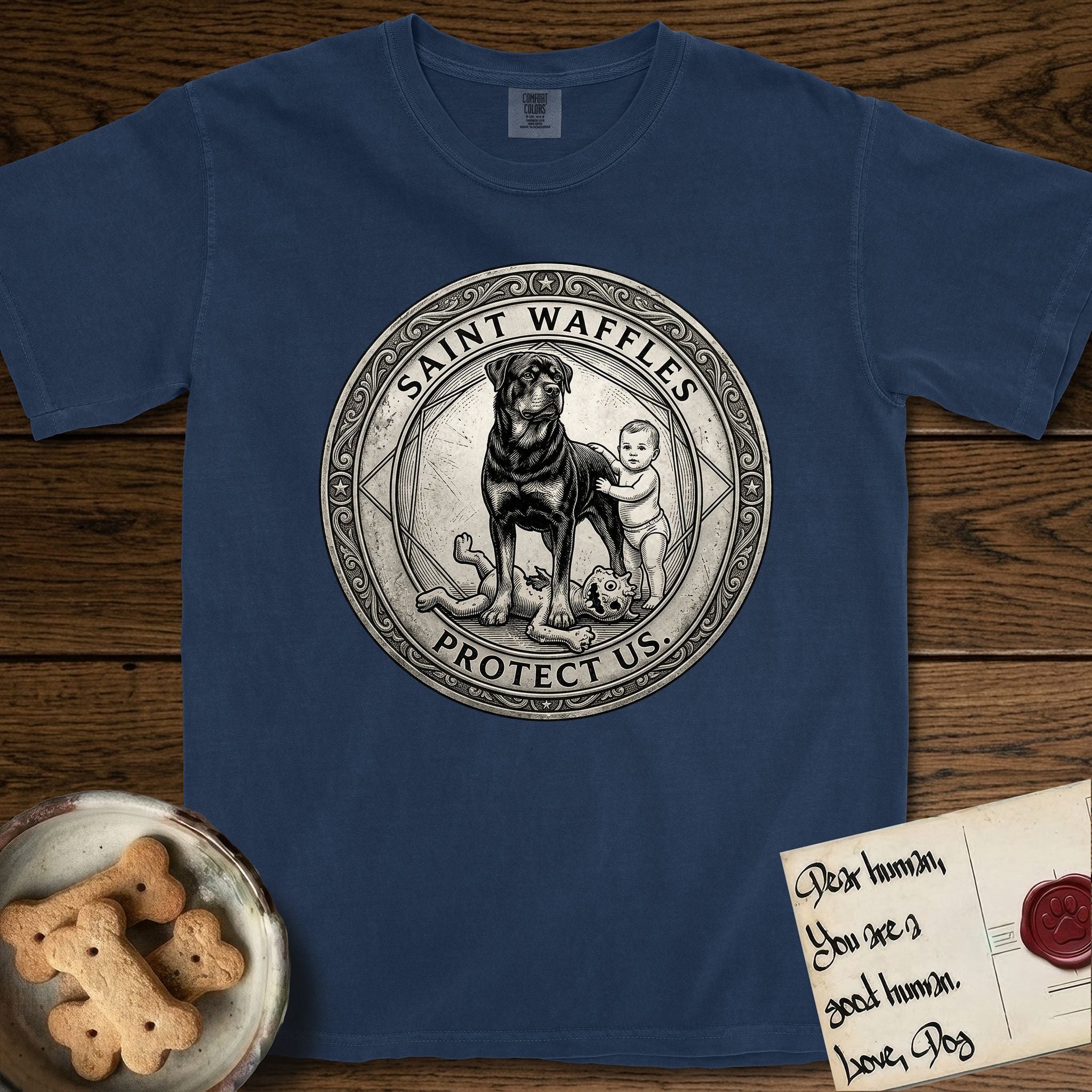 Patron Saint Medallion Saint Waffles T-Shirt flat lay in True Navy, featuring a vintage engraving coin medallion of a haloed Rottweiler standing guard over a small child, with the petition PROTECT US.