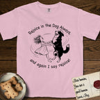Rejoice in the Dog Bernese Mountain Dog T-Shirt flat lay in Blossom, featuring a sparse pen-and-ink illustration of a girl and her Bernese Mountain Dog spinning together, her feet lifting off the ground.