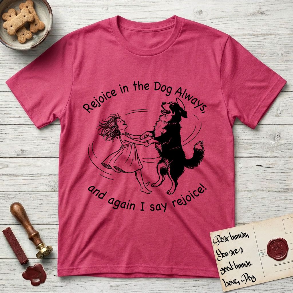 Rejoice in the Dog Bernese Mountain Dog T-Shirt flat lay in Heather Red, featuring a sparse pen-and-ink illustration of a girl and her Bernese Mountain Dog spinning together, her feet lifting off the ground.