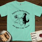 Rejoice in the Dog Bernese Mountain Dog T-Shirt flat lay in Island Reef, featuring a sparse pen-and-ink illustration of a girl and her Bernese Mountain Dog spinning together, her feet lifting off the ground.