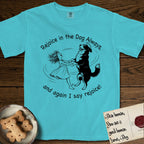 Rejoice in the Dog Bernese Mountain Dog T-Shirt flat lay in Lagoon Blue, featuring a sparse pen-and-ink illustration of a girl and her Bernese Mountain Dog spinning together, her feet lifting off the ground.