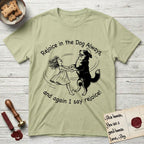 Rejoice in the Dog Bernese Mountain Dog T-Shirt flat lay in Pistachio, featuring a sparse pen-and-ink illustration of a girl and her Bernese Mountain Dog spinning together, her feet lifting off the ground.