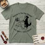 Rejoice in the Dog Bernese Mountain Dog T-Shirt flat lay in Sage, featuring a sparse pen-and-ink illustration of a girl and her Bernese Mountain Dog spinning together, her feet lifting off the ground.