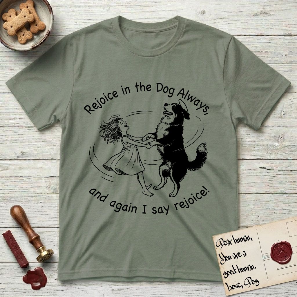 Rejoice in the Dog Bernese Mountain Dog T-Shirt flat lay in Sage, featuring a sparse pen-and-ink illustration of a girl and her Bernese Mountain Dog spinning together, her feet lifting off the ground.