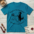 Rejoice in the Dog Bernese Mountain Dog T-Shirt flat lay in Tropical Blue, featuring a sparse pen-and-ink illustration of a girl and her Bernese Mountain Dog spinning together, her feet lifting off the ground.