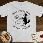Rejoice in the Dog Bernese Mountain Dog T-Shirt flat lay in White, featuring a sparse pen-and-ink illustration of a girl and her Bernese Mountain Dog spinning together, her feet lifting off the ground.