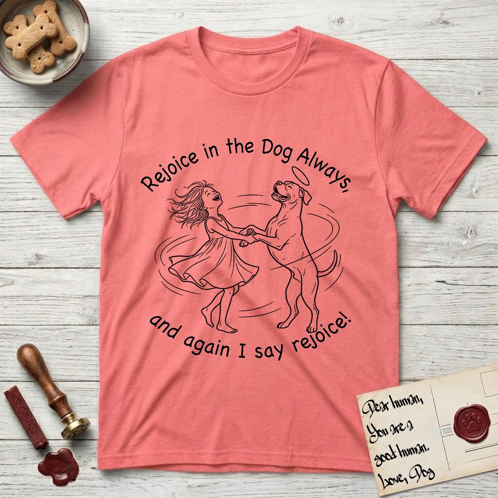 Rejoice in the Dog Boxer T-Shirt flat lay in Coral Silk, featuring a sparse pen-and-ink illustration of a girl and her Boxer dancing on his hind legs, both heads thrown back in joy.