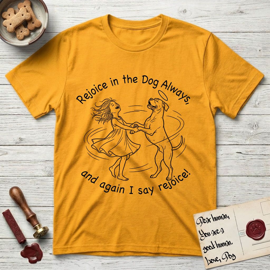 Rejoice in the Dog Boxer T-Shirt flat lay in Gold, featuring a sparse pen-and-ink illustration of a girl and her Boxer dancing on his hind legs, both heads thrown back in joy.
