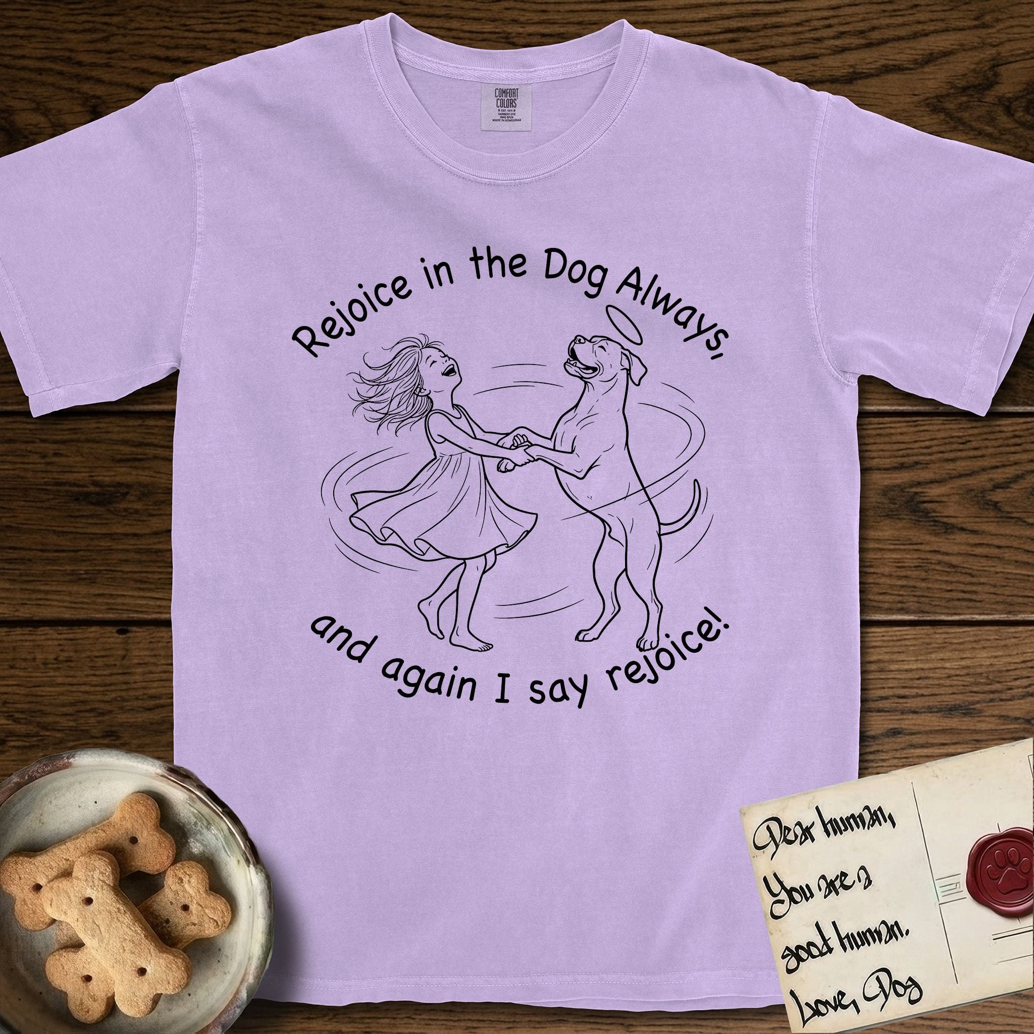 Rejoice in the Dog Boxer T-Shirt flat lay in Orchid, featuring a sparse pen-and-ink illustration of a girl and her Boxer dancing on his hind legs, both heads thrown back in joy.