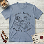 Rejoice in the Dog Boxer T-Shirt flat lay in Stone Blue, featuring a sparse pen-and-ink illustration of a girl and her Boxer dancing on his hind legs, both heads thrown back in joy.